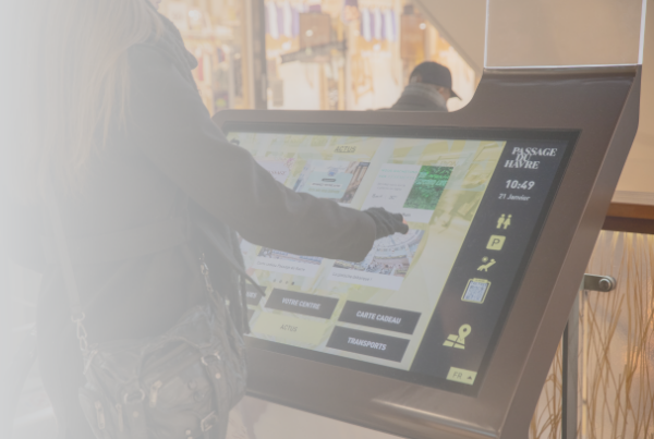 Person using an interactive wayfinding kiosk in a shopping center