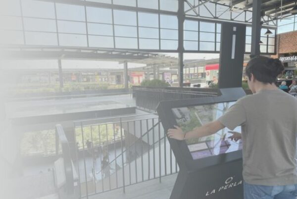 Visitor using a ViaDirect Gazelle interactive wayfinding kiosk at La Perla shopping center.