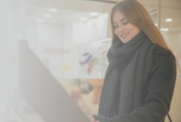 Visitor using a digital kiosk with an interactive wayfinding map
