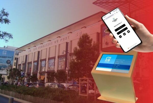 Les Terrasses du Port shopping centre in Marseille with a ViaDirect multitouch kiosk and mobile wayfinding interface in the foreground.