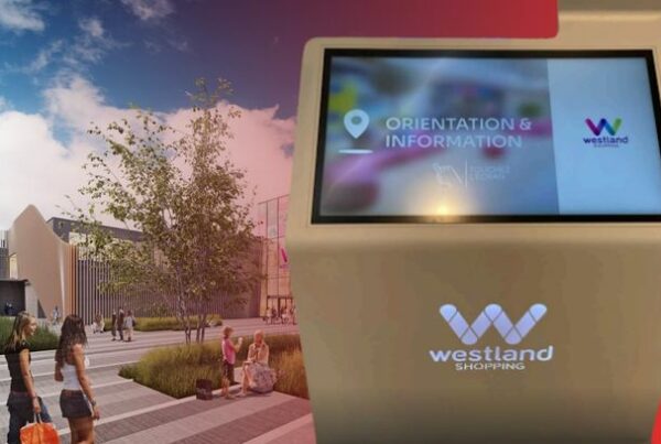 A composite image showing the exterior of Westland Shopping Centre alongside a close-up of a ViaDirect touch-screen wayfinding kiosk displaying an "Orientation & Information" interface.